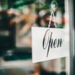 Open sign hanging in a storefront window